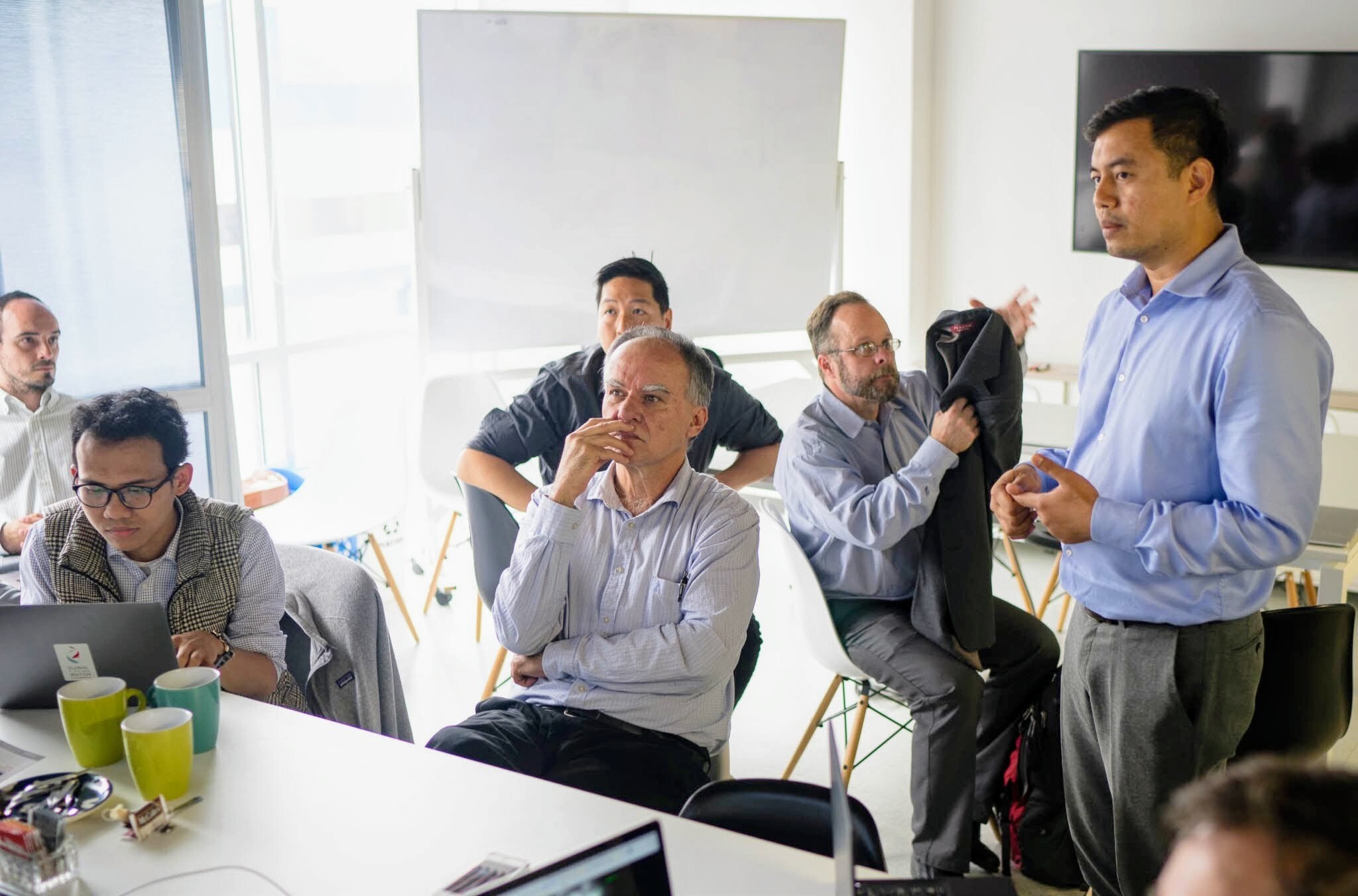 CoLab participants listening to a speaker during a collaborative workshop
